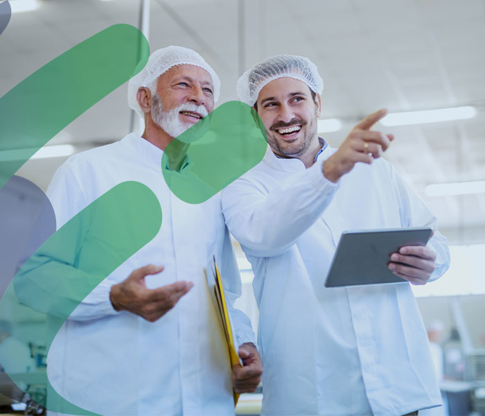 two men in a food manufacturing factory