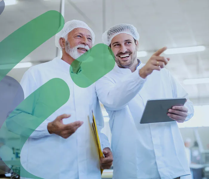 two men in a food manufacturing factory